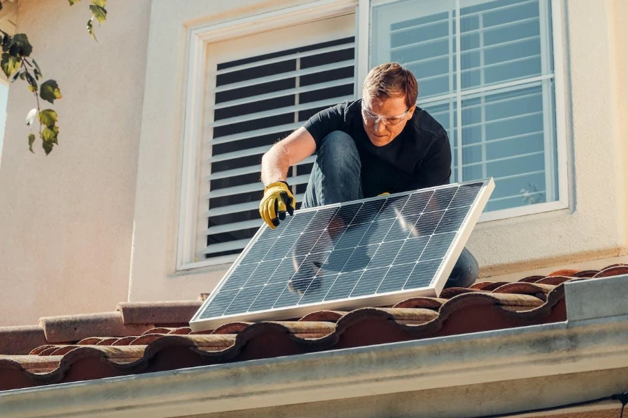Technician inspecting a solar panel on a rooftop
