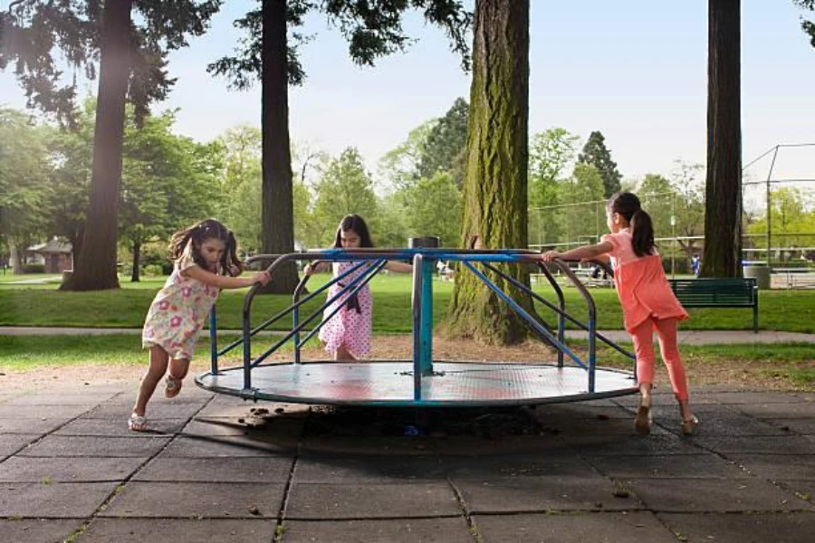 Three little girls spinning on a merry-go-round