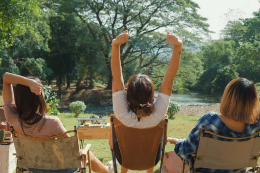 Three women sitting on different heavy duty camping chairs