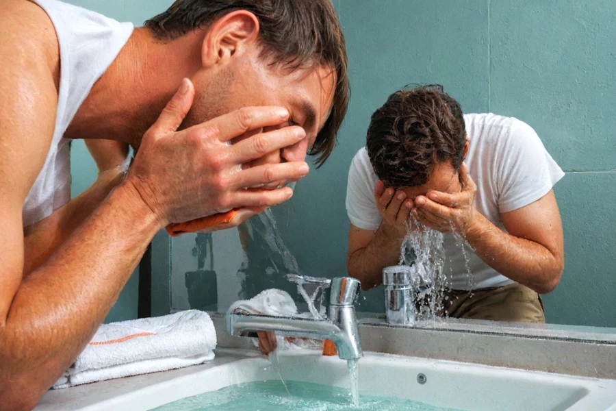 two men wash their faces