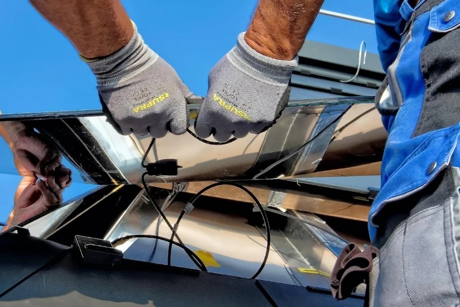 Two technicians repairing a solar module