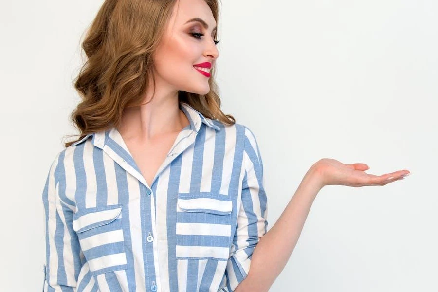 Woman posing in a white and blue-striped shirt