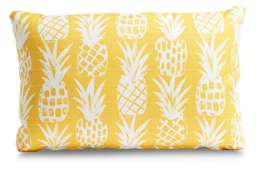A pineapple-themed outdoor accent cushion