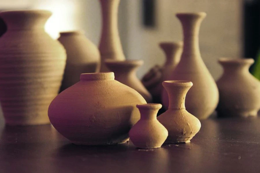 Brown ceramic pots on a brown surface