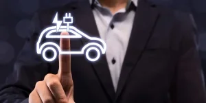 Businessman choosing EV car button on virtual screen