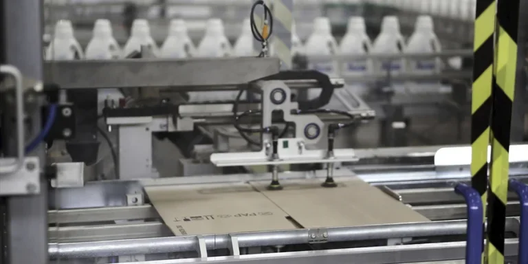 Cardboard boxes on conveyor belt in factory