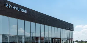 Cars of different colors are parked outside Hyundai dealership