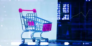 Double exposure Shopping cart trolley with laptop notebook and stock market display