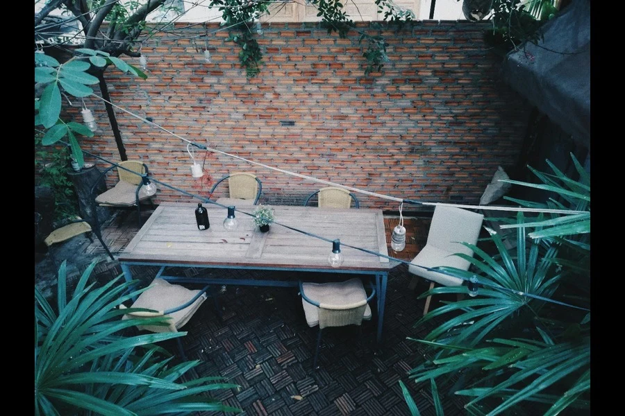 Rectangular, brown wooden table in a garden