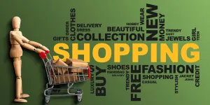 Shopping Wordcloud Collage With Wooden Man On Green Background