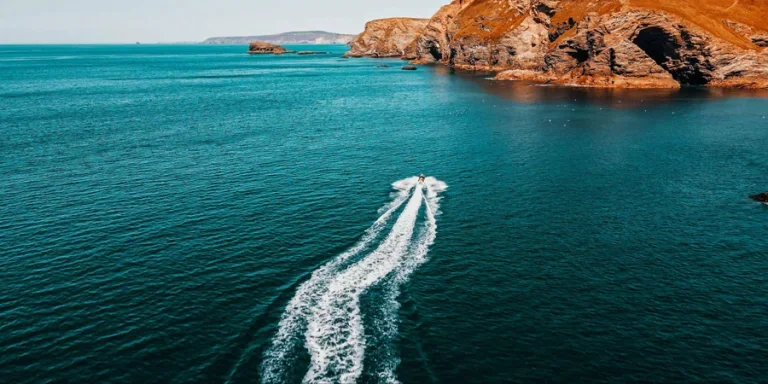 The jet ski is running towards the islet