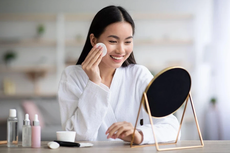 a beautiful woman is applying makeup