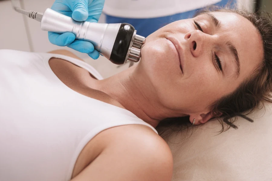 A lady getting RF therapy on the jaw