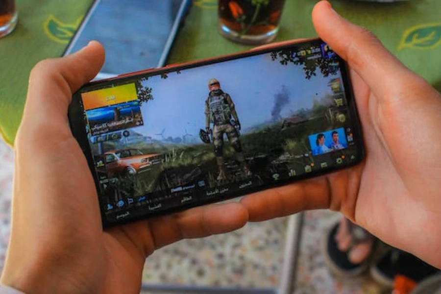 A person holding a gaming console with HD screen