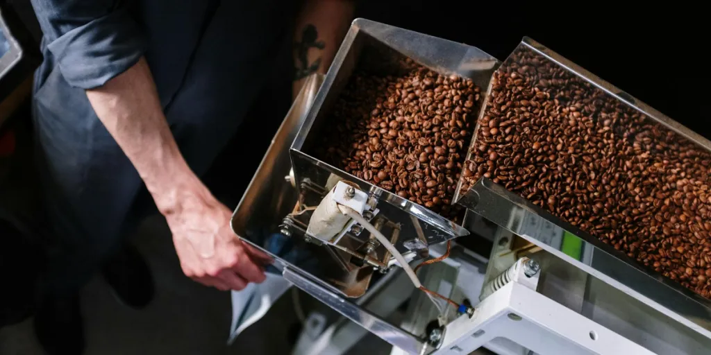 A person packaging coffee beans