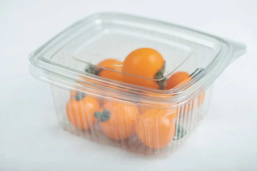 A plastic food storage container holding fruits