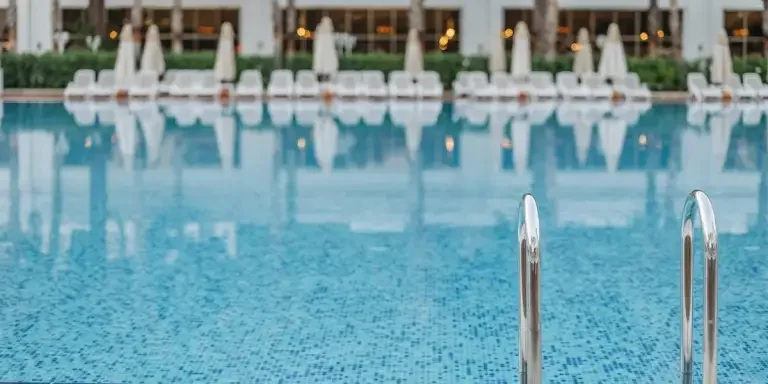 A steel pool ladder in an empty pool