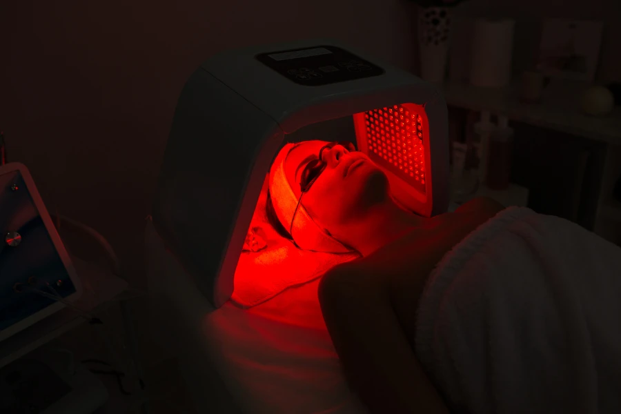A woman receiving red light therapy treatment