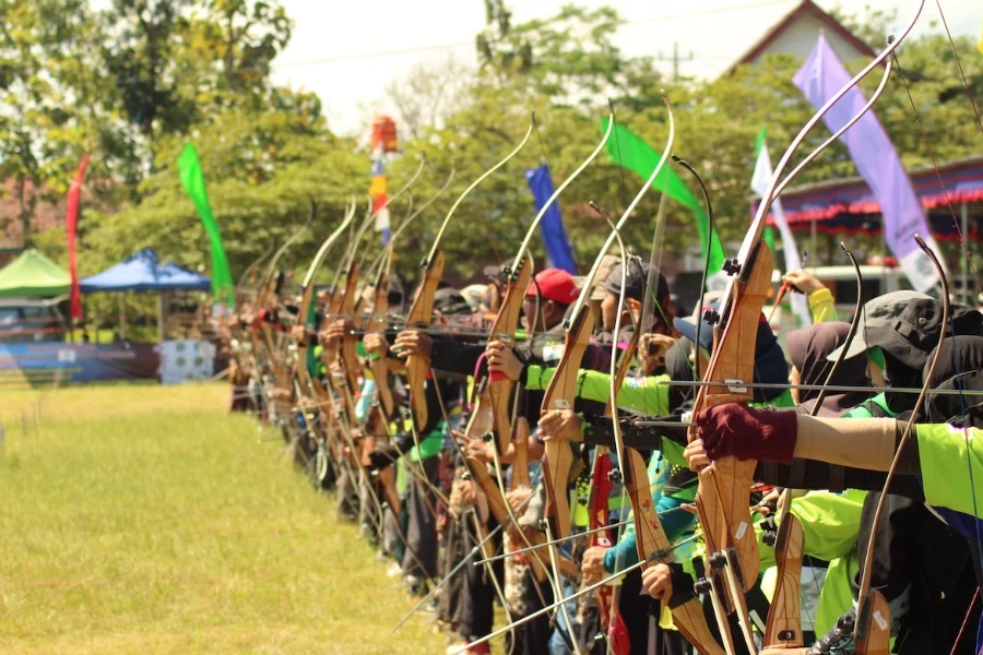 Lomba memanah dengan orang-orang berbaris siap menembakkan anak panah