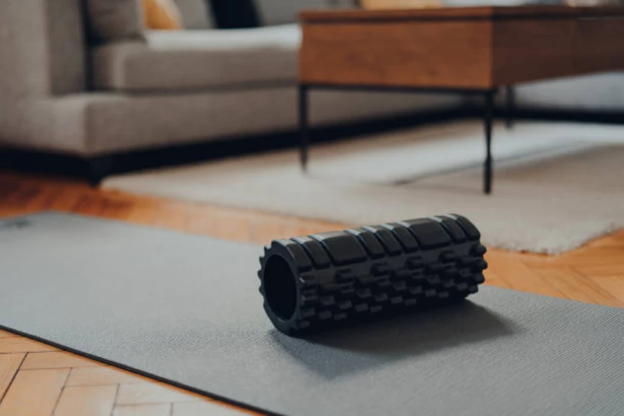 Black foam roller with spikes in a living room