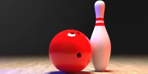 bowling pin with a red ball