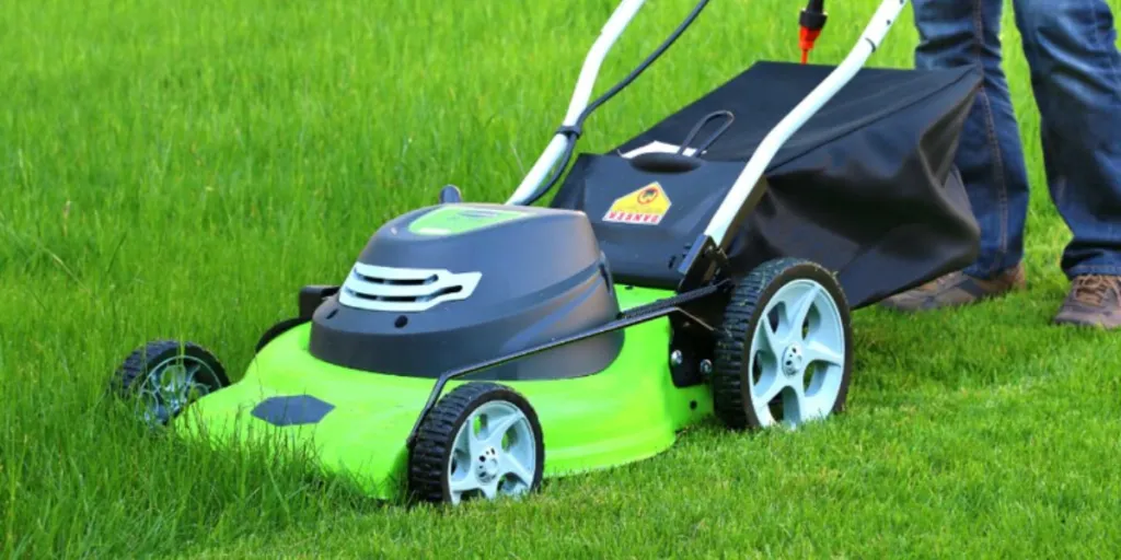Close-up of lawn mower in a field