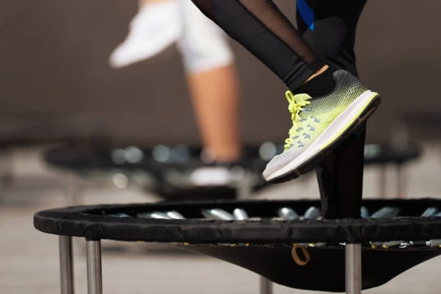 Exercise trampoline with person standing in the center of platform