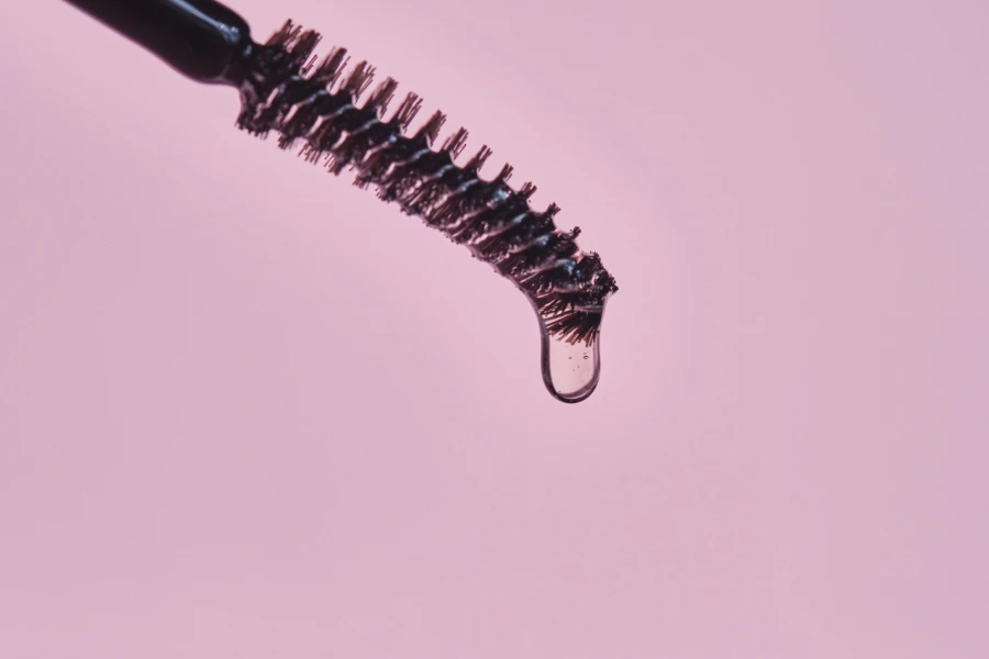 Eyebrow brush with gel on a pink background