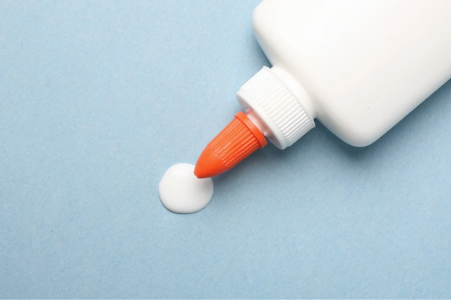 Eyebrow extension glue placed on a blue table