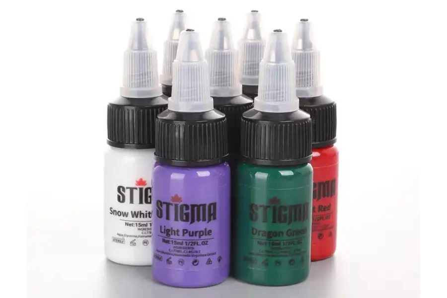Five tattoo ink bottles with transparent caps