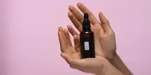 Hands holding a face serum