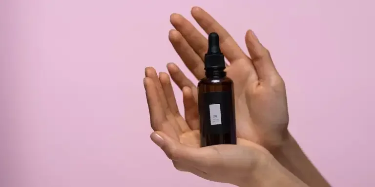 Hands holding a face serum