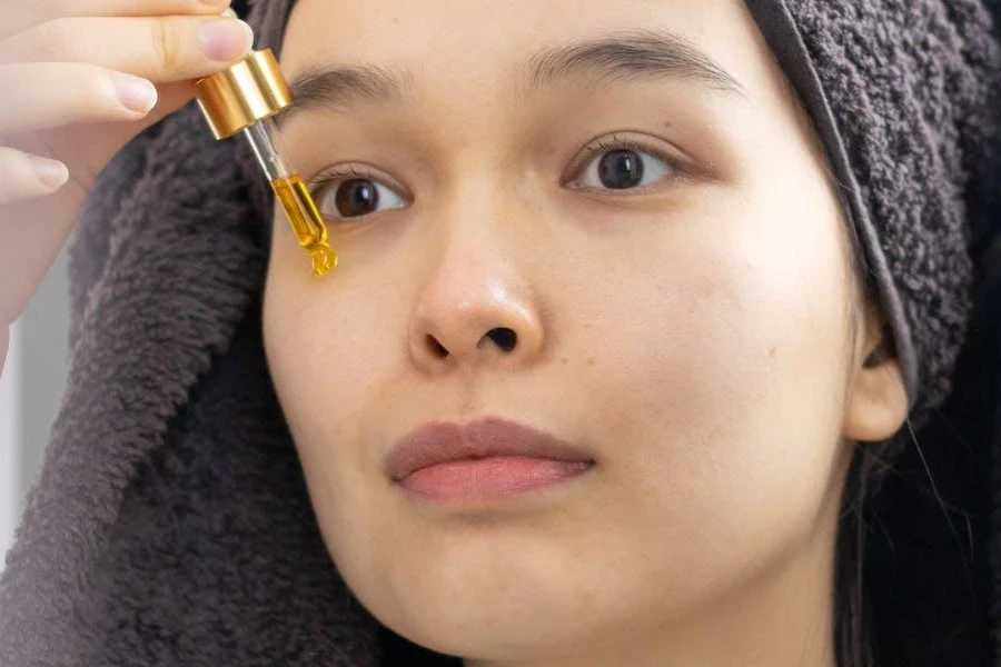 Lady applying a face serum