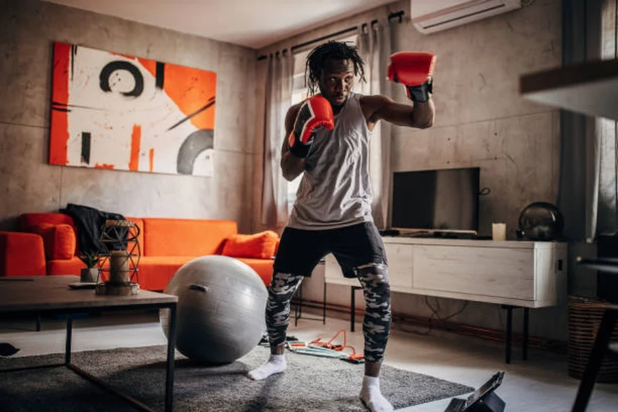 Man punching the air while wearing red and black gloves