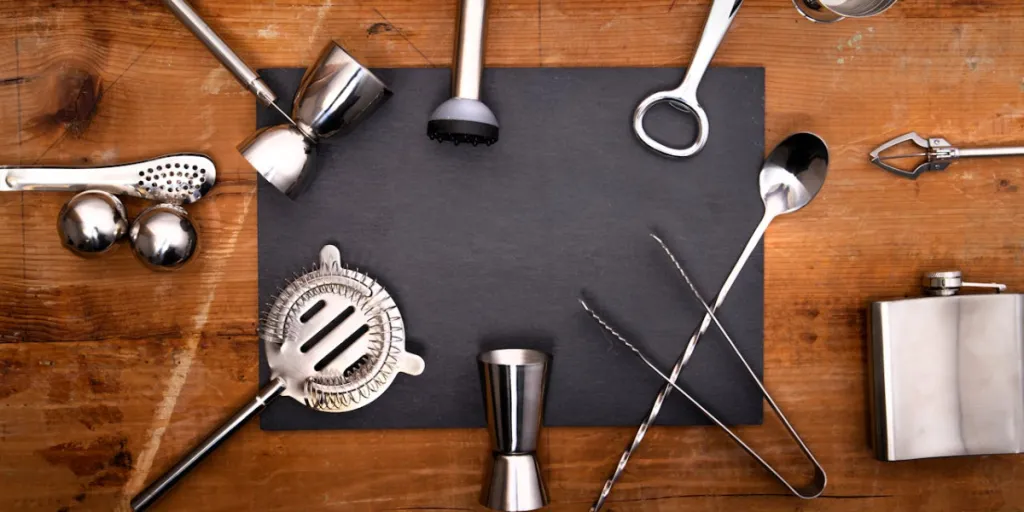 Overhead shot of various bar tools on a wooden surface