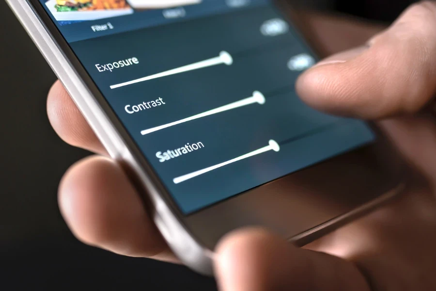 Person editing a photo using sliders on editing app