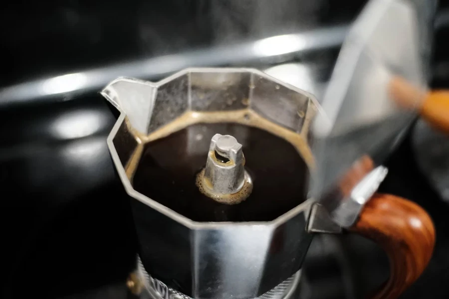 Top view of classic moka pot without lid and filled with coffee