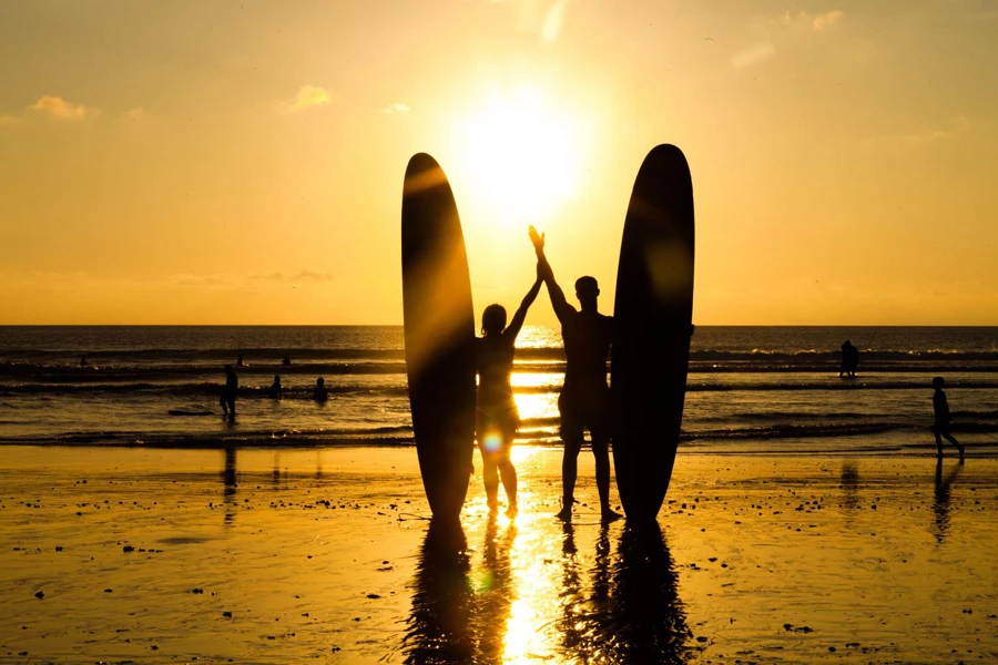 two surfers with longboards