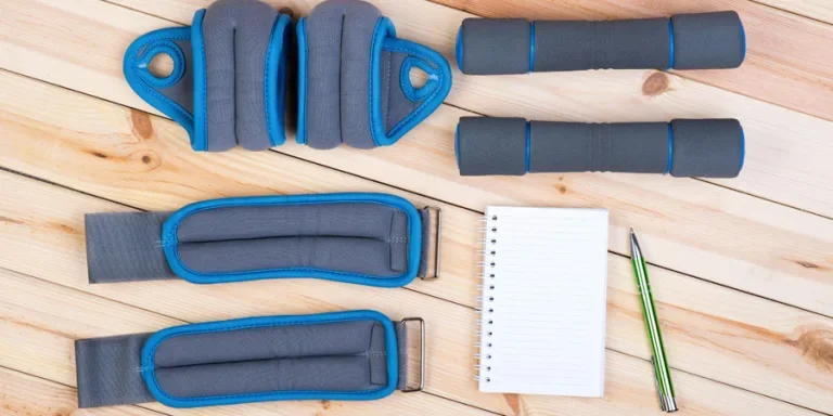 weights, dumbbells and notebook
