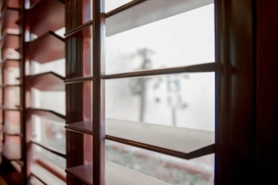 Windows with stained wood shutters