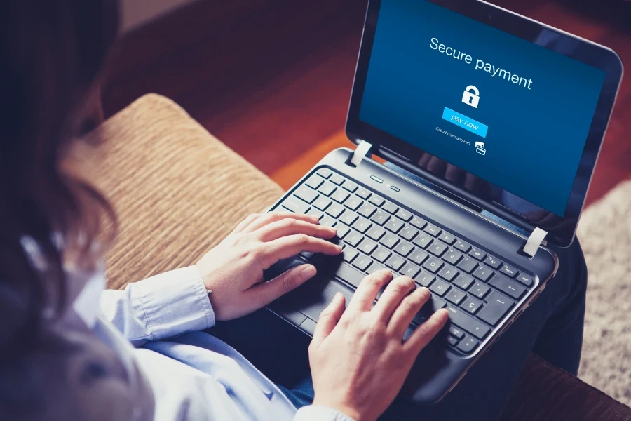 Woman making a secure payment on laptop