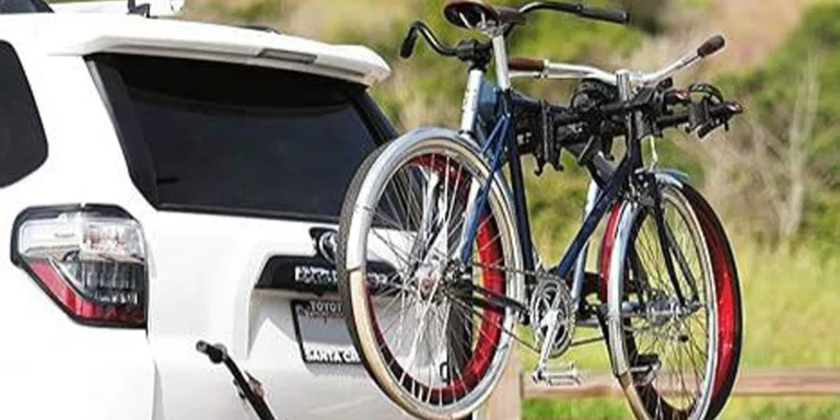 A bicycle on a bike rack behind a white car