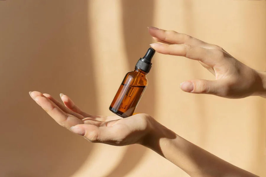 A bottle of serum in a woman's hands