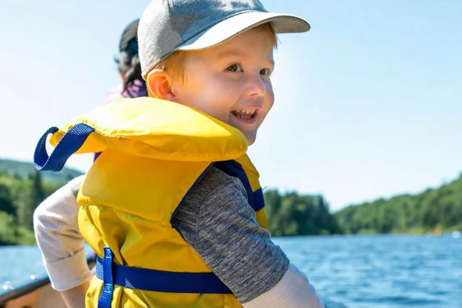 A child wearing a yellow inflatable life jacket