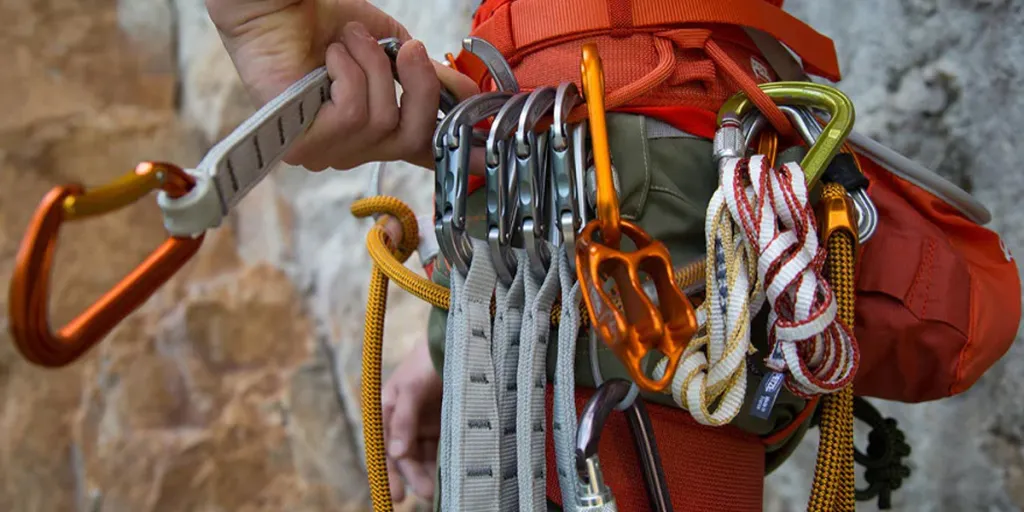 A climber equipped with multiple accessories