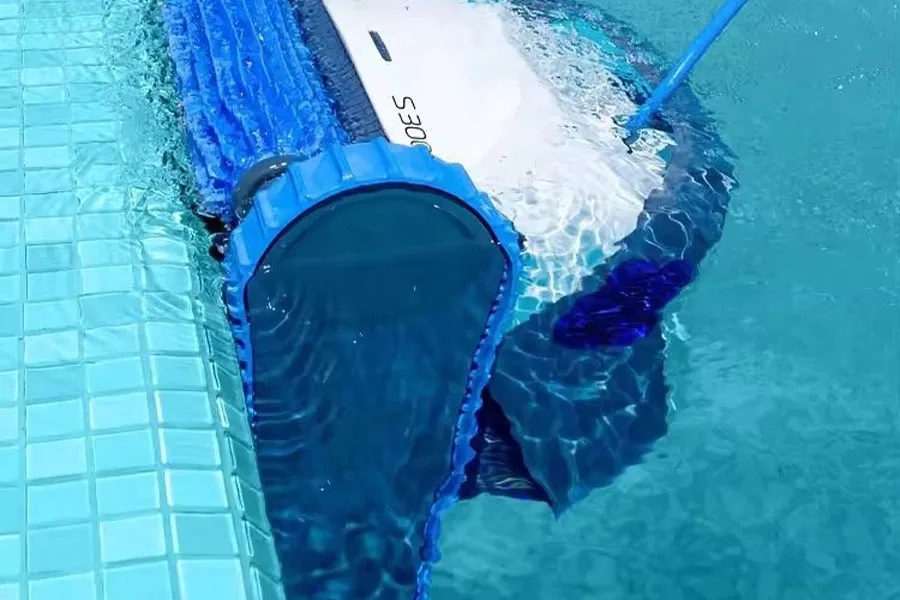 A corded pool robot cleaner submerged in water