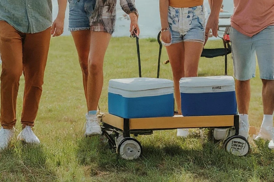 A group camping with coolers on folding wagons
