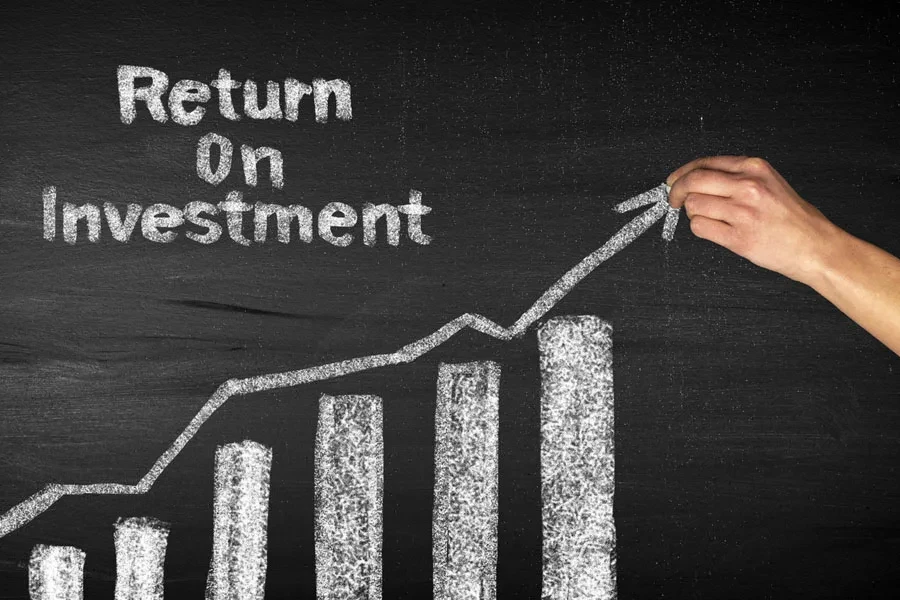 A hand drawing a rising ROI graph