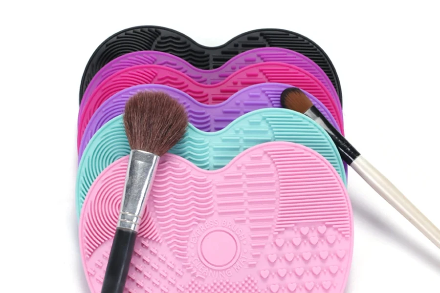 A makeup brush on a stack of cleaning mats