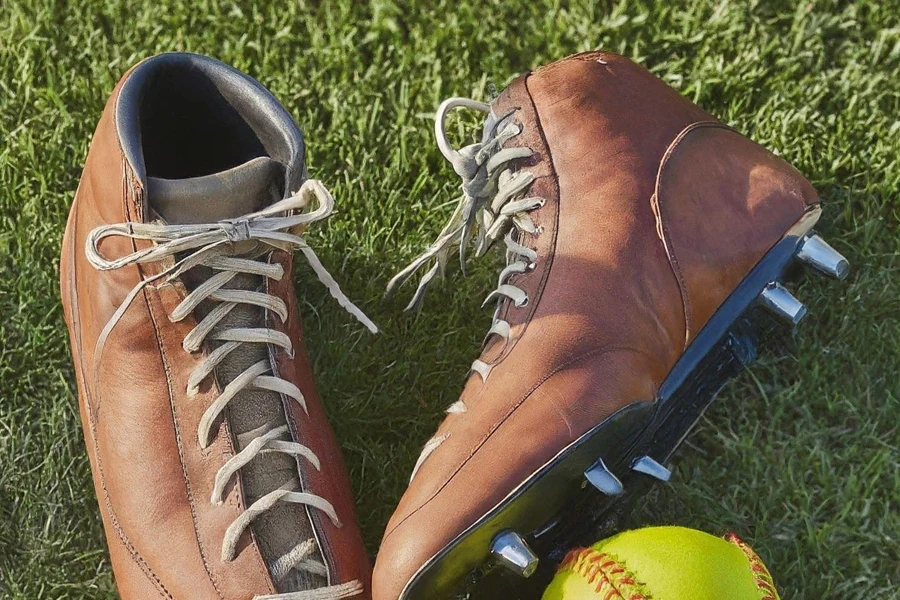 A pair of brown high-top leather softball cleats